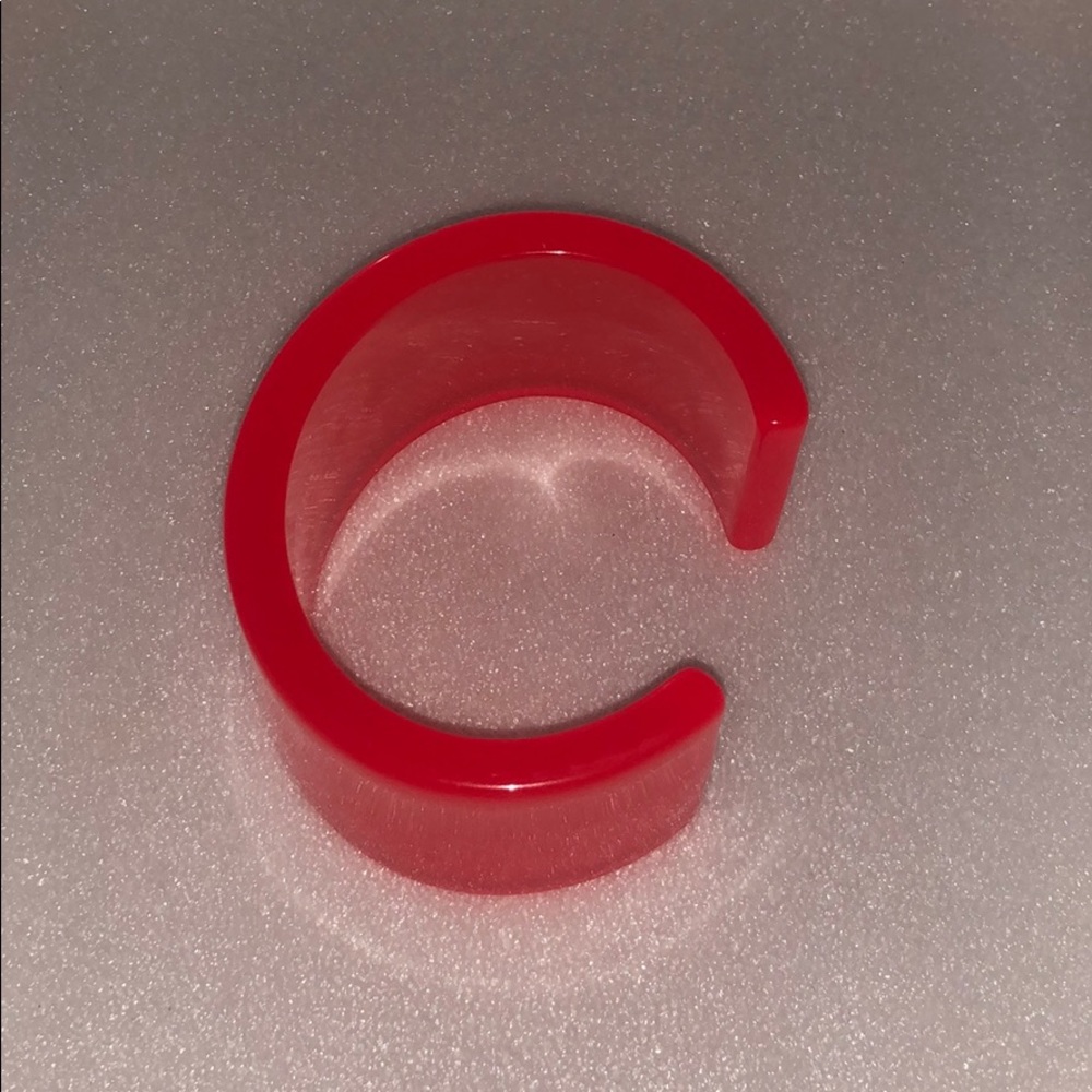 Orange bangle , cuff.  clear.